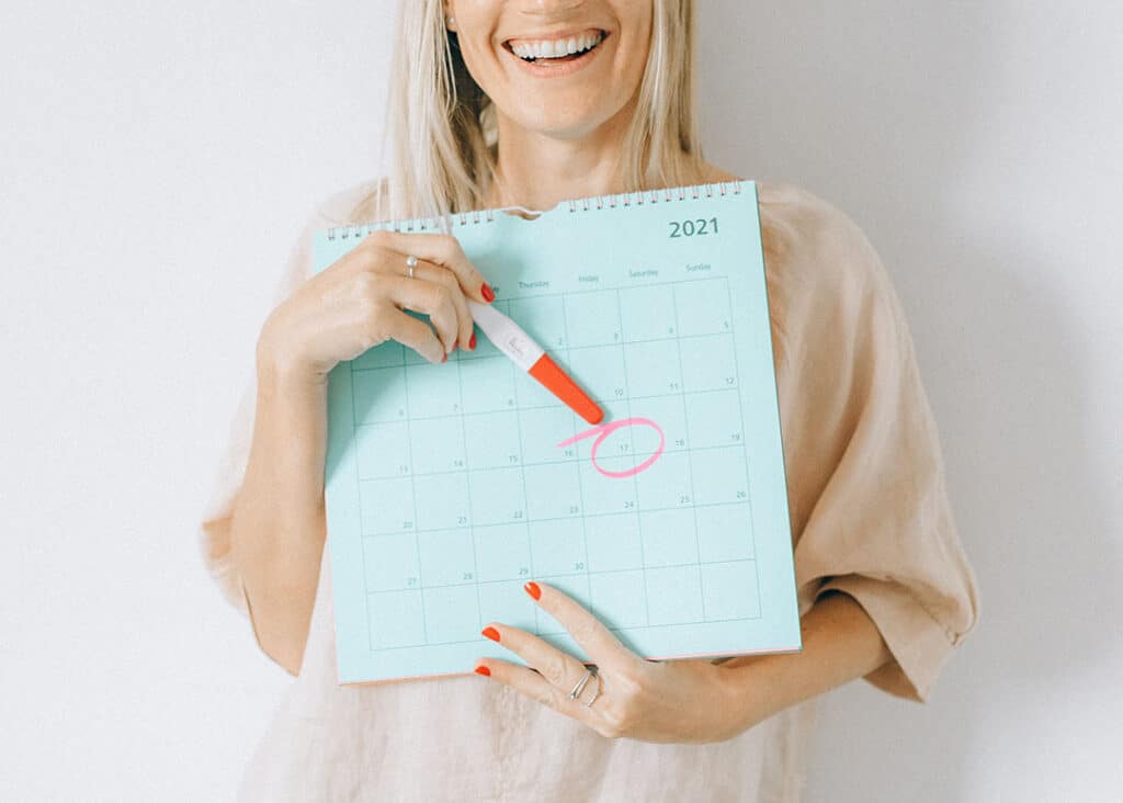 woman holding calendar with pregnancy date circled
